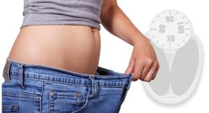woman showing loose jeans on stomach