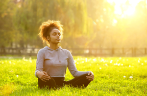 This image about girl meditating on grass